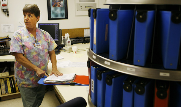 Connie Chapman, a nurse at Sac-Osage Hospital, looks through medical records at the hospital in Osceola, Missouri, Tuesday, July 14, 2009. (AP/Orlin Wagner)