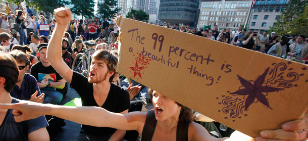 Occupy Boston protesters demonstrate on the plaza in front of the Federal Reserve Bank in Boston, October 8, 2011. People are demanding to know what elected officials are doing for the bottom 99 percent of Americans. The answer coming out of the House of Representatives is exactly the opposite of what’s needed. (AP/Michael Dwyer)