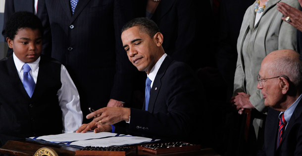 President Barack Obama signs the Affordable Care Act into law on March 23, 2010. Even with the ACA’s substantial savings, future growth in health care costs is a loom- ing threat to the federal budget and economy over the long term. (AP/Charles Dharapak)