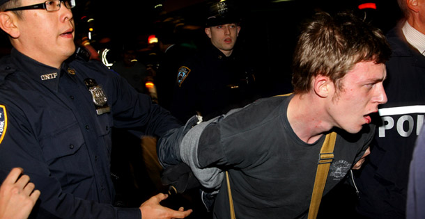 A protester is taken into custody after several arrests where made near Wall Street and Broadway after Occupy Wall Street march on October 5, 2011, in New York. (AP/Craig Ruttle)