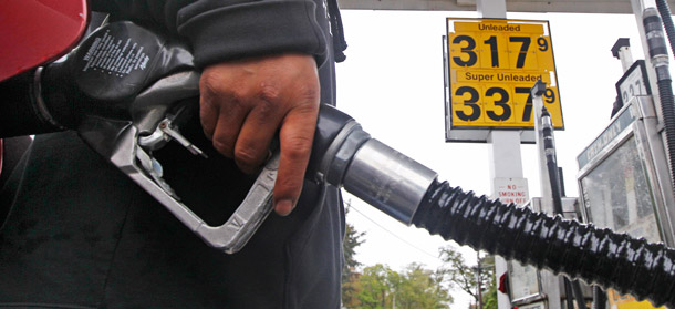 A gas station attendant fills up an automobile's tank in Wakefield, Massachusetts, on October 4, 2011. (AP/Charles Krupa)