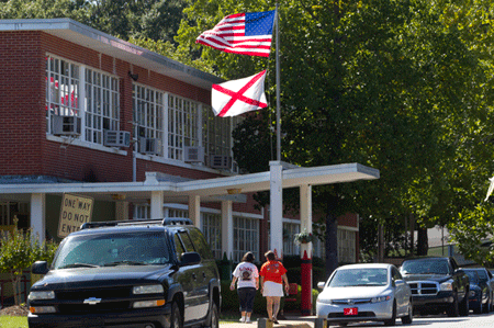 Mothers arrive to pick up their children from Flowers School in Montgomery, Alabama. In Montgomery County, more than 200 Hispanic students were absent the morning after the judge's ruling on the new immigration law. A handful withdrew. (AP/Dave Martin)