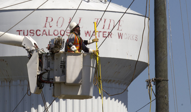 Alabama Power linemen work to restore power to neighborhoods in Tuscaloosa, Alabama. While Alabama Power is a nongovernmental  electric company and has not required proof of citizenship, under H.B. 56, undocumented immigrants won’t be able to enforce the terms of a  contract they enter into with the company. (AP/Dave Martin)