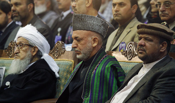 Afghan President Hamid Karzai, center, Afghan First Vice President Qasim Fahim, right, and Chairman Sebghatullah Mujadidi attend a <i>loya jirga</i>, or grand council, in Kabul, Afghanistan, Wednesday, November 16, 2011. (AP/Musadeq Sadeq)