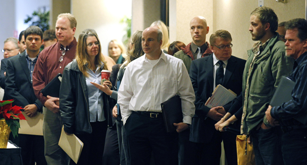 People wait in line to enter a job fair, Friday, December 2, 2011, in, Portland, Oregon. Congress should pass the rest of the American Jobs Act to help the  economy find a sure footing and provide some relief to the large numbers  of Americans still struggling in an uncertain job market. (AP/Rick Bowmer)