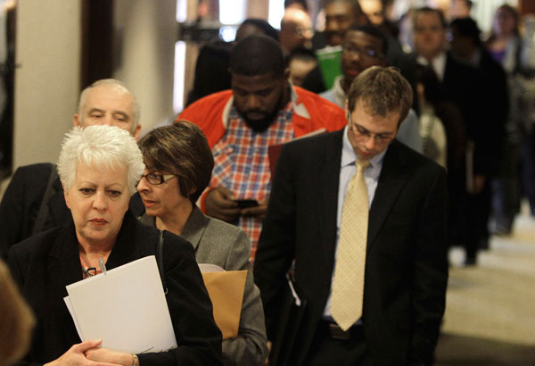 Mary Polocy, left, stands in line and waits to enter a career fair, in  Independence, Ohio. Polocy has been unemployed for three months and is  looking for a job. (AP/Tony Dejak)