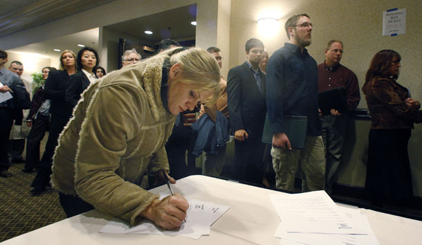 Sharri Pegg fills out a registration form during a job fair Friday, December 2, 2011, in Portland, Oregon. (AP/Rick Bowmer)
