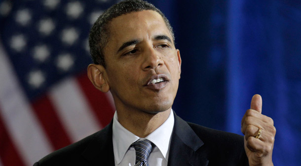 President Obama gestures while speaking about the economy on December  6, 2011, at Osawatomie High School in Osawatomie, Kansas. The president suggested that the middle class are the key to economic growth. (AP/Charlie Riedel)