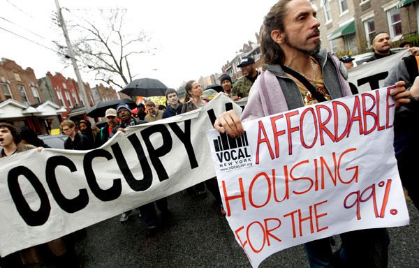 Occupy Wall Street activists march during a tour of foreclosed homes in the East New York neighborhood of the Brooklyn borough of New York in early December. (AP/Mary Altaffer)