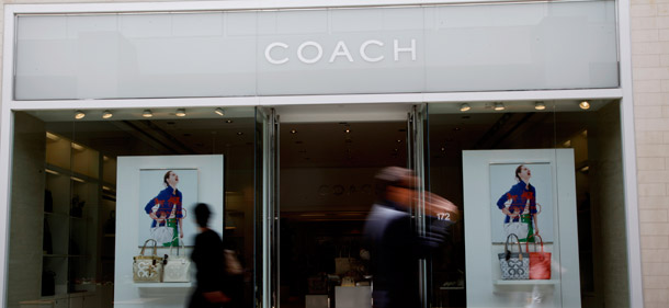 Shoppers walk past a Coach retailer in Los Angeles. Consumption has grown by only 5.0 percent in inflation-adjusted terms from June 2009, when the economic recovery officially started, to September 2011. This slow growth is largely due to heavy debt burdens, which the payroll tax would help relieve. (AP/Reed Saxon)