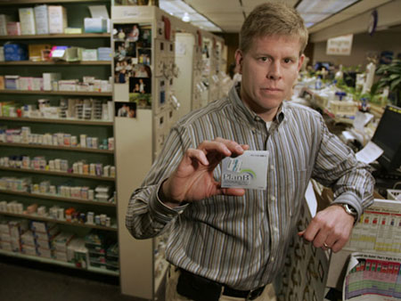 Pharmacist Matt Hartwig holds up a dose of Plan B, which is commonly referred to as the morning-after pill, at his pharmacy in Excelsior Springs, Mo. (AP/Charlie Riedel)