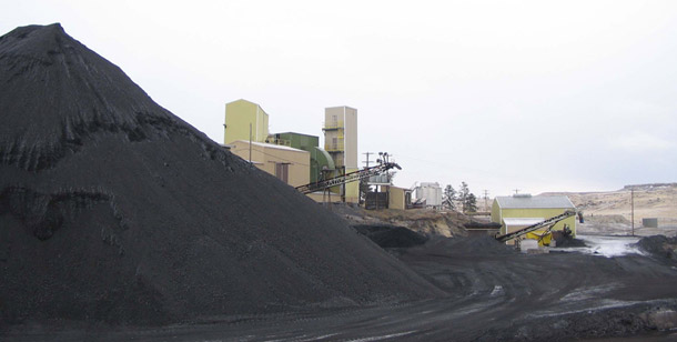 Stockpiled coal sits next to idled equipment at the Bull Mountain mine south of Roundup, Montana. Some utilities and coal companies want to water down new mercury emissions reductions. (AP/Matthew Brown)