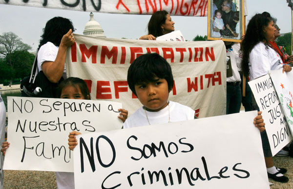 Fatima Tapia, 6, left, and Joed Sosa, 5, both of Manassas, Va., hold signs in Spanish that say, "Don't separate our families," and "We are not criminals," during an immigrant rights rally in front of the Capitol in Washington. (AP/Jacquelyn Martin)