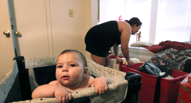 Zenobia Bechtol and her 7-month-old daughter Cassandra are seen  in the dining room of her mother's apartment in Austin, Texas, on December 14, 2011, after Bechtol and her boyfriend were evicted from their  apartment after he lost his job. High unemployment as well as poverty continue to affect many Americans. (AP/Erich Schlegel)