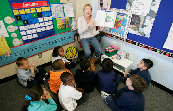 Teacher Kim Hemmis reads a book to her first grade class at Will Rogers Elementary School in Houston. President Obama's proposed changes to the federal competetive grant program will ensure teacher quality and a better education for our nation's children. (AP/David J. Phillip)