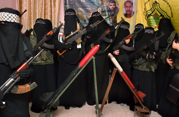 Female Palestinian militants from the Al Aqsa Martyrs Brigades, who claim they are willing to be suicide bombers, hold weapons during a news conference in Jebaliya, northern Gaza Strip, in May 2007. (AP Photo/Hatem Moussa)