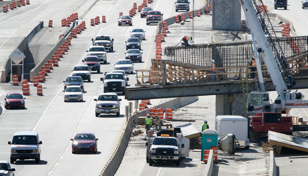 Highway construction, much like this scene on Interstate 430 and 630 in Little Rock, Arkansas, and other forms of infrastructure development are essential to creating jobs and boosting the economy. (AP/Danny Johnston)