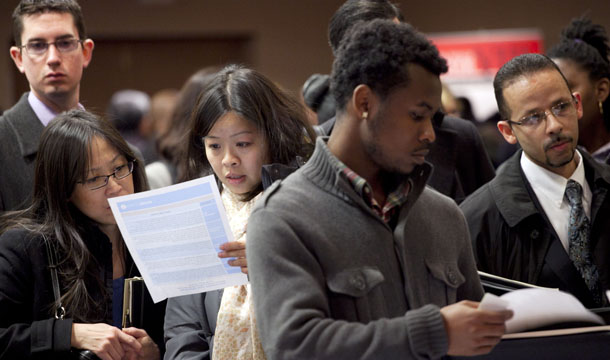 People wait to talk with potential employers at a job fair sponsored by National Career Fairs in New York, Monday, December 12, 2011. (AP/Mark Lennihan)