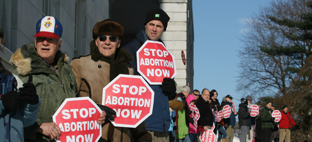 Participants in an annual antiabortion rally surround the state house  in Augusta, Maine on January 14, 2012 for the "Hands Around the Capitol Rally and March"  held each year to recognize the anniversary of the U.S. Supreme Court's  <i>Roe vs. Wade</i> decision. (AP/Joel Page)