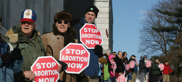 Participants in an annual antiabortion rally surround the state house in Augusta, Maine on January 14, 2012 for the "Hands Around the Capitol Rally and March" held each year to recognize the anniversary of the U.S. Supreme Court's <i>Roe vs. Wade</i> decision. (AP/Joel Page)