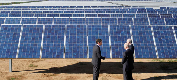Recurrent Energy Chief Executive Officer Arno Harris, left, talks with Gov. Jerry Brown, center, and Interior Secretary Ken Salazar, right, while touring the Recurrent Energy solar project in Elk Grove, California on January 13, 2012. Increasing electricity generation from clean sources such as wind and solar can increase domestic manufacturing and create jobs. (AP/Rich Pedroncelli)