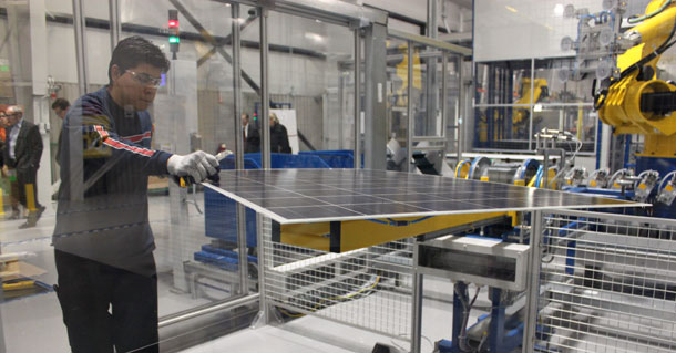 Schott Solar employee Jose Zaragosa trims a photovoltaic panel in a glass room at the company's plant in Albuquerque, N.M. A strong clean energy industry will give rise to more American manufacturing jobs and in turn will help rebuild our struggling middle class and create a more sustainable and fair economy (AP/ Susan Montoya Bryan)