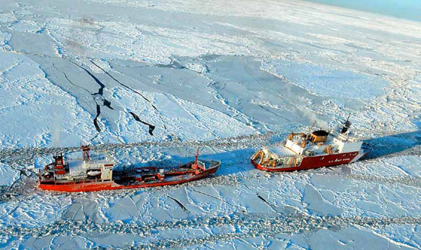 The Coast Guard Cutter Healy escorts the Russian-flagged tanker Renda 250 miles south of Nome on January 6. The vessels are transiting through ice up to five-feet thick in this area. (AP/US Coast Guard, Petty Officer 1st Class Sara Francis)