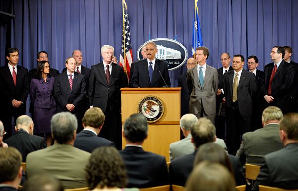 Attorney General Eric Holder, center, accompanied by Housing and Urban Development Secretary Shaun Donovan, right, Iowa Attorney General Tom Miller, and other federal and state officials, announces a settlement regarding mortgage loan servicing and foreclosure abuse. (AP/Cliff Owen)