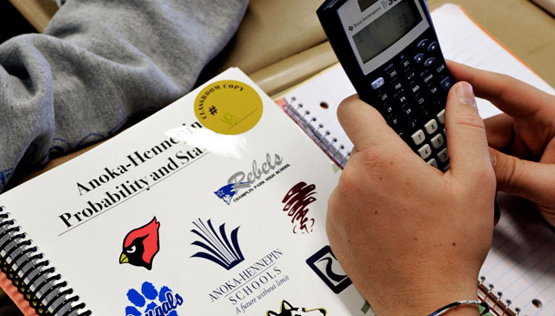 A Blaine (MN) High School student is shown with a printed online textbook. Instead of mass-produced textbooks, the more than 3,100 sophomores in the state's largest district are learning from an online curriculum developed by their teachers over the summer with free software distributed over the web. (AP/ Jim Mone)