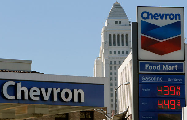 Chevron gas prices in downtown Los Angeles. An additional 25 cents in the price per gallon of gas at the pump every three months equals an additional $5 billion in the bank for the big five oil companies. (AP/ Damian Dovarganes)