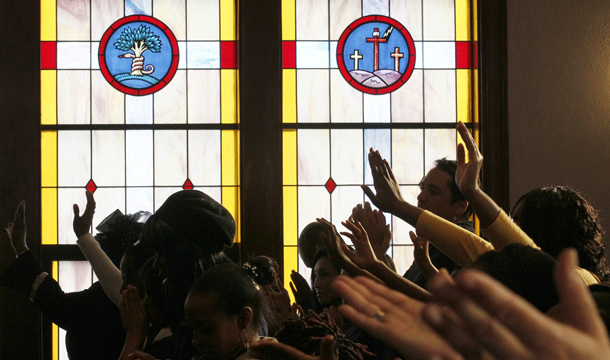 Members of the congregation worship during a church service at Pentecostal Tabernacle in Cambridge, Massachusetts. The small church, sitting between the Massachusetts Institute of Technology and Harvard University, has attracted students from Asia, Africa, Europe, and Latin America. (AP/Winslow Townson)