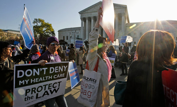 Supporters of health care reform rally in front of the Supreme Court in Washington, as the court heard arguments on the health care law signed by President Barack Obama.<br /> (AP/Charles Dharapak)