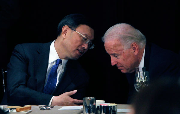 Chinese Foreign Minister Yang Jiechi, left, talks with U.S. Vice President Joe Biden at a luncheon on in February. China's historic nonintervention foreign policy strategy is changing as it becomes a more prominent world power.<br /> (AP/Damian Dovarganes)