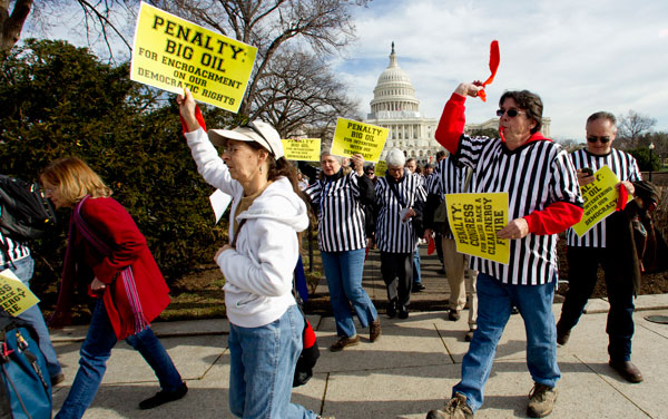 Protestors against the Keystone XL pipeline dressed as referees "blow their whistles on fossil fuel funded corruption in Congress" and wave red flags, as they march on Capitol Hill in Washington in January 2012. (AP/Manuel Balce Ceneta)
