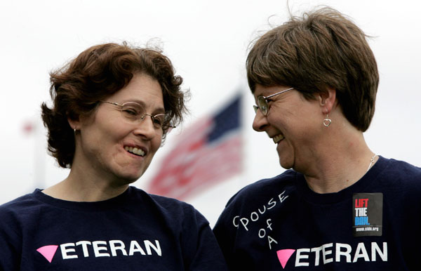 Lesbian Army Sgt. Tina Stidman, left, smiles with her domestic partner Julie Snider, right, during a 2005 rally in California to support gay and lesbian rights in the military. Lesbian couples were three times more likely to serve in the U.S. military between 1990 and 2000 compared to women generally.  (AP/Paul Sakuma)