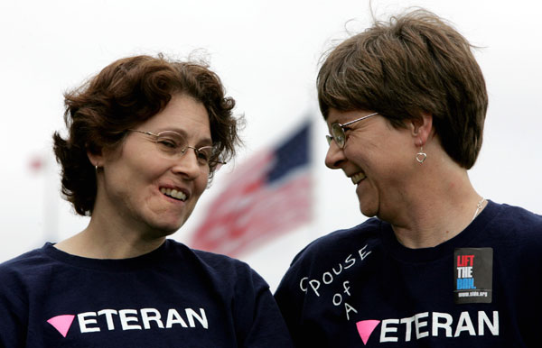 Lesbian Army Sgt. Tina Stidman, left, smiles with her domestic partner Julie Snider, right, during a 2005 rally in California to support gay and lesbian rights in the military. Lesbian couples were three times more likely to serve in the U.S. military between 1990 and 2000 compared to women generally. (AP/Paul Sakuma)