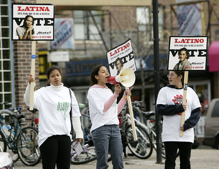 High school students—from left, Jessica Tejada, Vanessa Bonventura and Bianca Salazar—work to get out the vote as part of a class civics program in the heavily Latino East Boston neighborhood of Boston, Tuesday, November 2, 2004. (AP/Michael Dwyer)