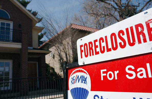 A foreclosure sign outside of a home. Fannie Mae, Freddie Mac, and the Federal Housing Finance Agency could prevent foreclosures by combining principal reduction with 