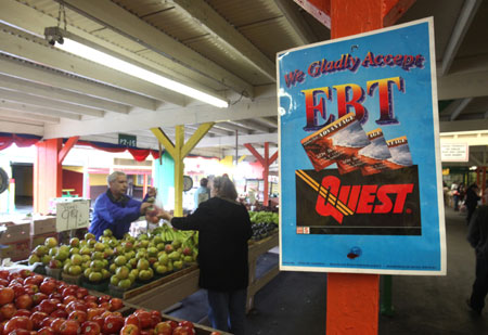 A sign announcing the acceptance of electronic benefit transfer cards, which allow for electronic food stamp payments, at a farmers market in Roseville, California. (AP/ Rich Pedroncelli)
