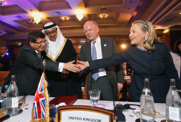 U.S. Secretary of State Hillary Rodham Clinton, right, meets with  Turkey's Foreign Minister Ahmet Davutoglu, left, United Arab Emirates'  Foreign Minister Sheikh Abdullah bin Zayed al-Nahyan second left, and  British Foreign Minister William Hague at the Friends of Syria Conference in Tunis. (AP/ Jason Reed)