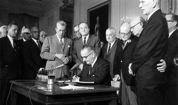 In this July 2, 1964, file photo, President Lyndon B. Johnson signs the Civil Rights Act in the East Room of the White House in Washington. (AP)