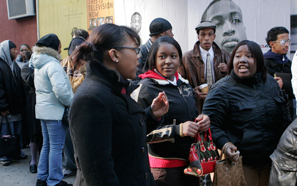 Lacqrecia Verley, center, Daniqua Williams, second from right, and Seiella Springer, right, join a line of hundreds of people seeking to apply for employment at an M&M's World store in New York. Black and Latina women are disproportionately unemployed and paid less for their work. (AP/Mark Lennihan)