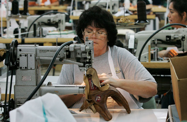 An unidentified worker sews together the parts that make up a baseball glove at the Nokona Baseball Glove Company in Nocona, Texas. (AP/ Orlin Wagner)