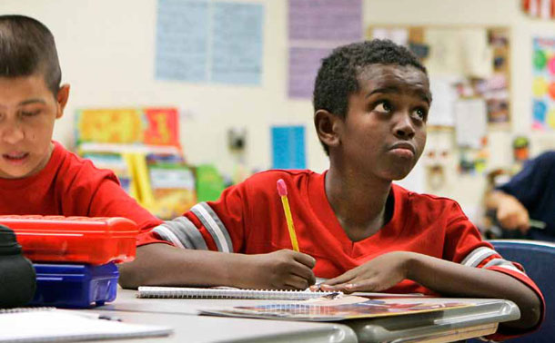 Mohammad Noor copies a word off the board during an ELL class at the Walnut Middle School in Grand Island, Nebraska.
<br /> (AP/Nati Harnik)