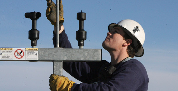 A wind plant supervisor looks at wind gauges on the top of a wind turbine at the PPM Energy wind farm, in Wasco, Oregon. Federal, state, and local policymakers, as well as the private sector, can take steps to produce more clean energy and grow the economy, reduce pollution while saving energy and dollars, and build more resilient and balanced economies and communities. (AP/Rick Bowmer)