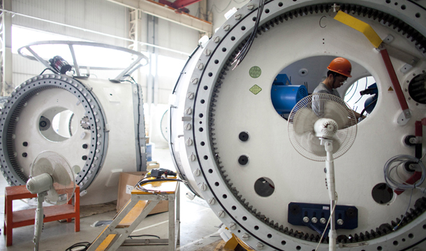 A worker assembles mechanic parts of a wind turbine at a factory of Guodian United Power Technology Co., Ltd., in Baoding, in northern China's Hebei province, Monday, June 20, 2011. Wind power industry is expected to generate approximately 34,000 green jobs in China annually between 2011 and 2020 (including power generation and manufacturing). (AP/Alexander F. Yuan)