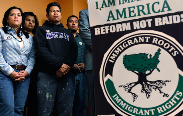 Adriana Martinez, left, and Paula Bonilla, who work for the immigrant rights group CASA de Maryland, and day laborers Juan Alberto Morales and Wilber Gonzalez listen to a media event about an ICE raid that occurred in Baltimore in 2007.
<br /> (AP/Jacquelyn Martin)