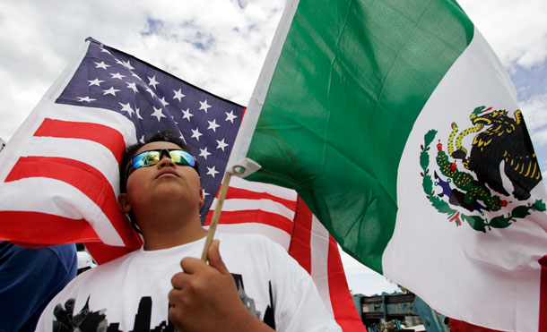 Jose Martinez, 14, holds up an American and Mexican flag at a 2007 rally in California for a simplified path to citizenship. A recent Pew study reports that migration from Mexico is down.
<br /> (AP/Paul Sakuma)