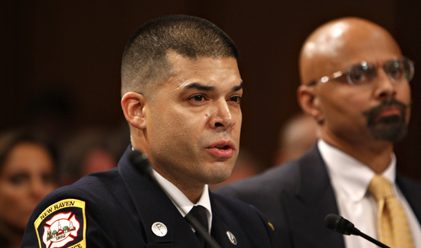 New Haven, Connecticut, firefighter Ben Vargas testifies on Capitol Hill in Washington, Thursday, July 16, 2009. U.S. Commission on Civil Rights member Peter Kirsanow is at right. Vargas and other firefighters in New Haven were plaintiffs in <i>Ricci vs. DeStefano</i>, the reverse discrimination lawsuit that was overturned by the Supreme Court in their favor. (AP/Charles Dharapak)