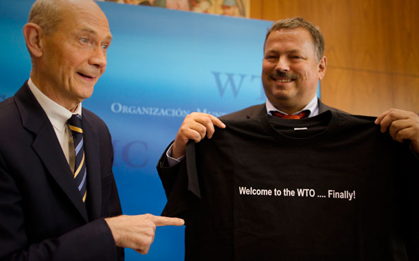 Pascal Lamy, left, director-general of the World Trade Organization, hands over a t-shirt with a logo saying "Welcome to the WTO...finally!" to Maxim Medvedkov, the chief WTO negotiator for the Russian Federation. With Russia's entrance to the organization, the U.S. trade policy toward Russia needs to be revisited.
  (AP/Anja Niedringhaus)